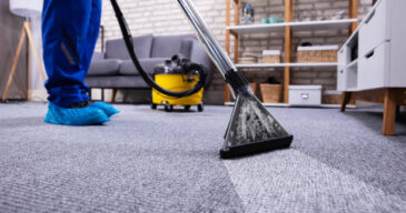 Human Cleaning Carpet In The Living Room Using Vacuum Cleaner At Home